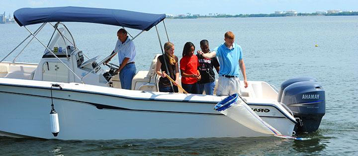Students on a research vessel in the water.